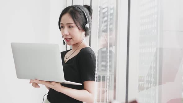 Happy business woman working by video conference with laptop from home.