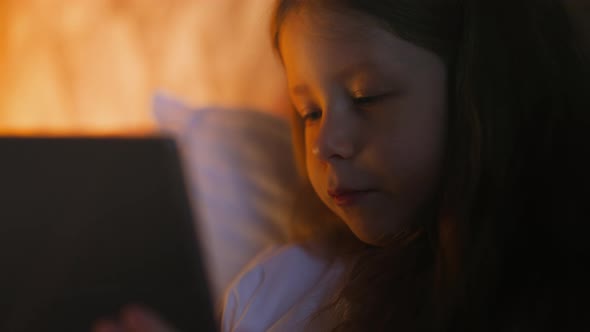 Cute Little Girl Makes Facepalm Gesture Looking at Tablet