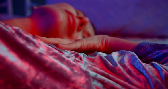 Woman Is Sleeping in Her Bed at Night Time, Dreaming and Resting in Home, Closeup View