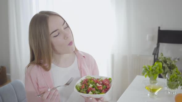 Portrait of Happy Caucasian Woman Eating Fresh Spring Salad of Tomatoes, Cucumbers and Greenery