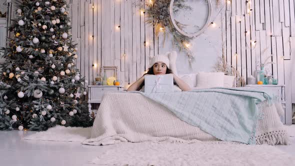 Sad and Bored Teenager at Home in the Bedroom Celebrates the New Year Alone in Quarantine