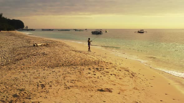 Man angling on beautiful lagoon beach adventure by blue sea and clean sand background of Gili Air ne