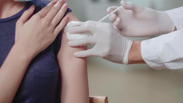 Close Up Medical Doctor In Safety Gloves Is Making A Vaccine Injection To A Female Patient