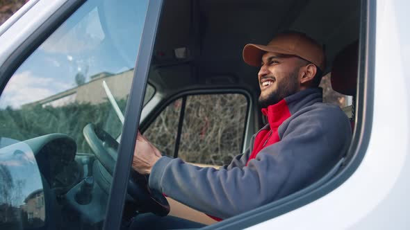 Happy Indian Courier Using Tablet in the Van