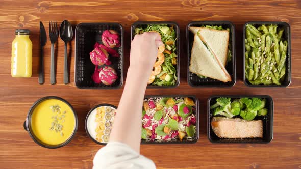 Food Delivery Top View Take Away Meals in Disposable Containers on Wooden Table