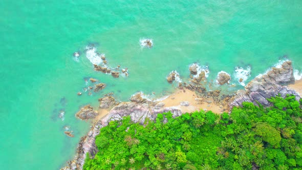 An aerial view from a drone flying over beautiful beaches and rocks