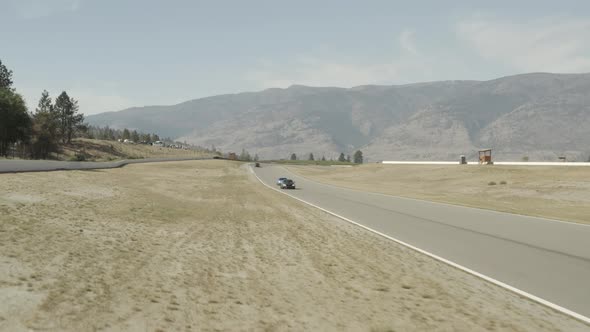 McLaren supercars driving on motor racing circuit, Osoyoos race track, Area 27 Luxury Motorsports Cl