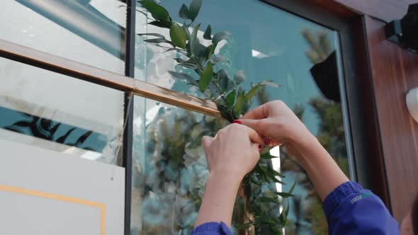 Hands Decorate the Arch with Leaves