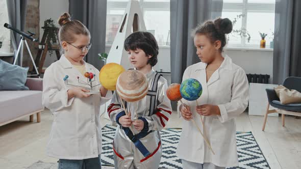 Portrait of Cute Kids with Toy Planets
