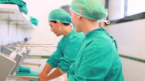 Nurses putting hands and forearms under water