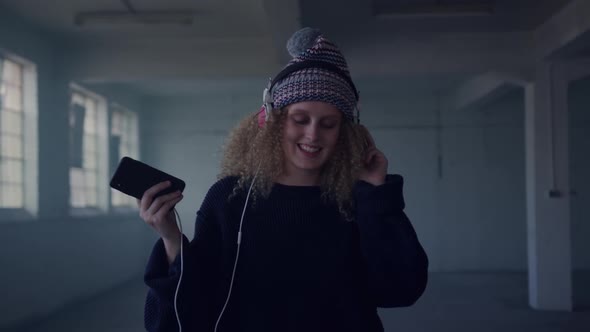 Fashionable young woman in an abandoned warehouse