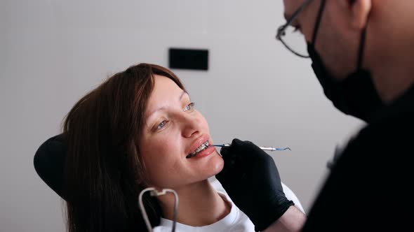 An Orthodontist Checks the Braces and Jaws of a Woman