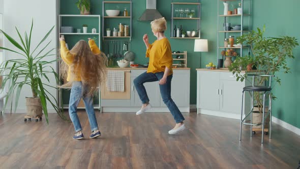 Cheerful Mom and Teenage Girl Jumping Fooling Around Having Fun Mental Health