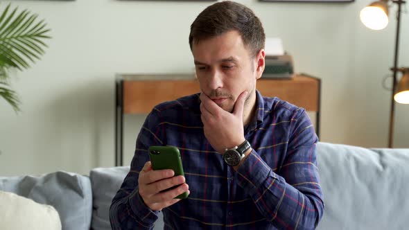 Thoughtful Person Is Sitting Couch Smartphone His Hand Looking Phone Thinking