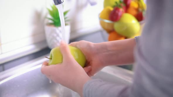 Woman Washing Green Apple