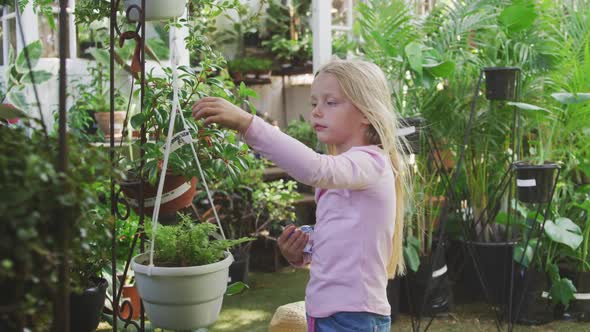 Little girl gardening in a greenhouse