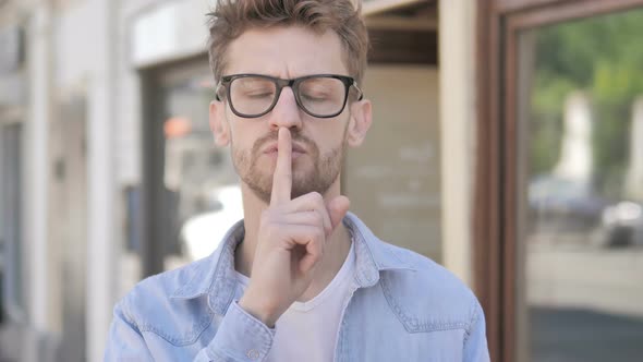 Silence Please, Finger on Lips by Young Man