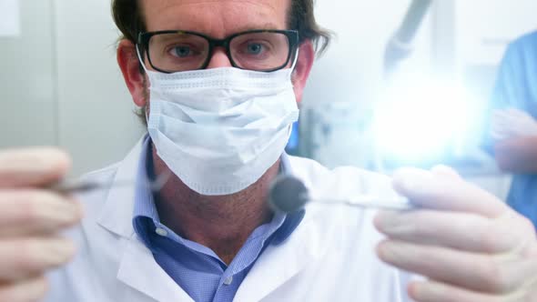 Dentist holding dental tools