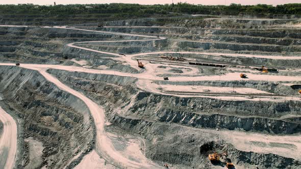 Aerial View of Opencast Mining Quarry with Lots of Machinery at Work  View From Above