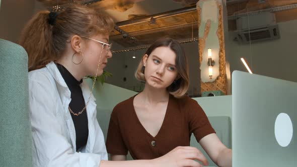 Young Girls Work Remotely in a Cafe on the Summer Terrace