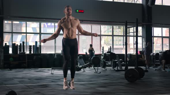 Young male athlete exercising cardio with jump rope, cardio and endurance training