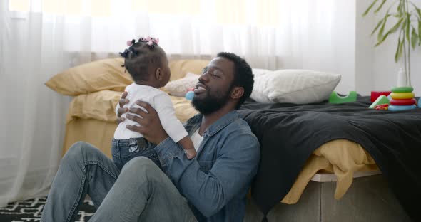 Dad and Toddler Daughter Having Fun Playing at Home