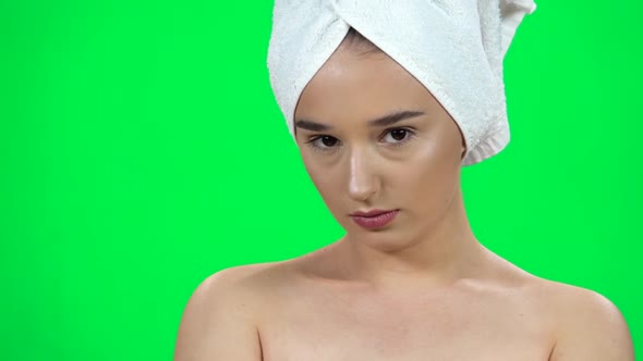 Girl in Towel on Her Head Is Very Offended Then Smiling on Green Screen at Studio. Close Up. Slow