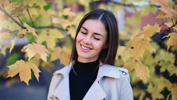 Closeup Woman Smiling Posing Outdoor at Autumn Yellow Foliage