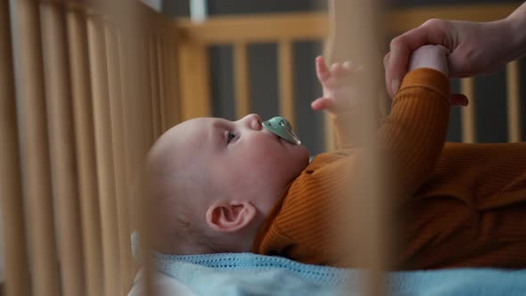 Young Mom Gives Baby a Pacifier