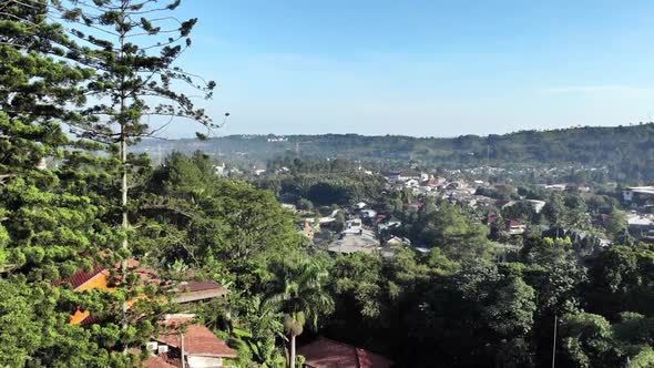 Cinematic aerial view of suburban area with a beautiful mountain in the back and clear blue sky in t