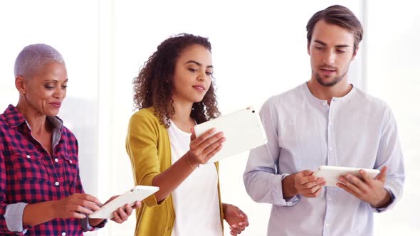 Smiling executives using digital tablet