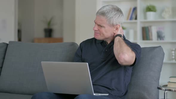 Tired Middle Aged Businessman Having Neck Pain on Sofa