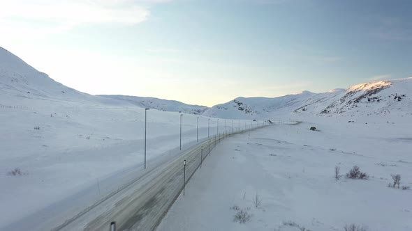 Norwegian winter road crossing at Eldrevatn in Hemsedal mountain between east and west - Sunset aeri