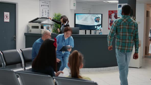 Busy Hospital Reception Waiting Area with Patients in Row