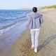 Girl in Tracksuit Runs Along the Coast - VideoHive Item for Sale