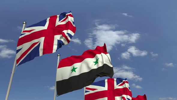 Flags of Syria and the United Kingdom Against Blue Sky