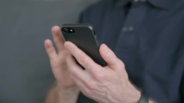 Close Up of Hands of Man Using Smartphone