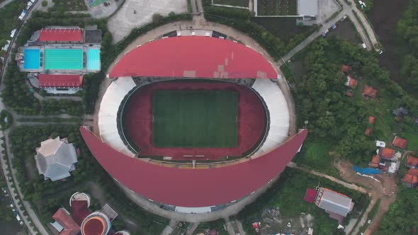 Aerial top down view of the Beautiful scenery of Wibawa Mukti Stadium when sunrise