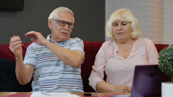 Senior Couple Checking Papers, Domestic Bills, Planning Budget Investment Loan Insurance Payment