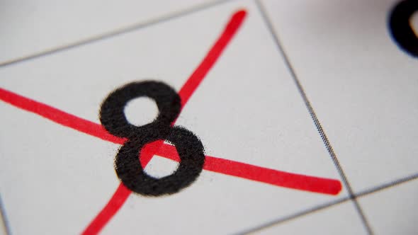 The 8St Number in the Calendar is Crossed Out with a Red Cross in a Macro on a White Sheet