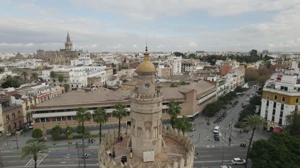 Half drone orbit around historic Torre del Oro watchtower, Seville, Spain