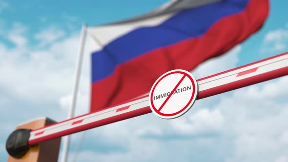 Barrier Gate with No Immigration Sign Opened Near Flag of Russia
