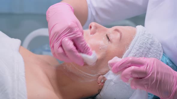 Cosmetologist Performs the Procedure of Cleansing and Moisturizing the Skin