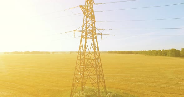 Vertical Movement Flight Near High Voltage Electricity Tower and Power Lines at Green and Yellow