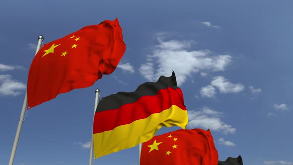 Waving Flags of Germany and China on Sky Background