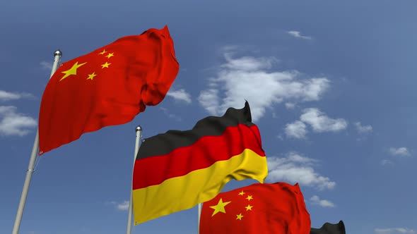 Waving Flags of Germany and China on Sky Background alt