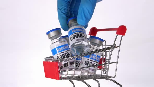 Glass vials for Covid-19 vaccine in shopping cart on white background.