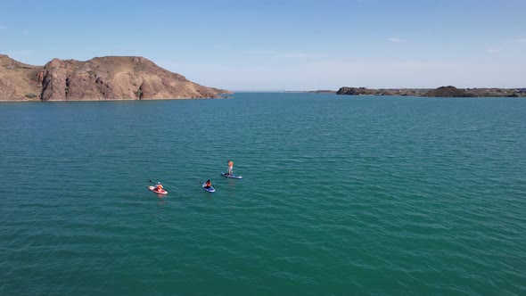 A Group of People Ride Sup Surfing in the Lake