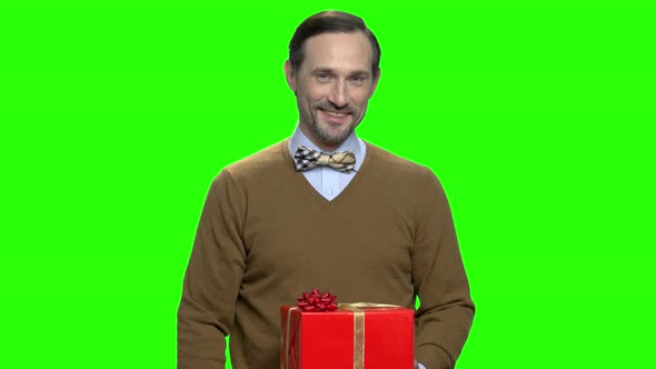 Pleasant Man Giving Red Christmas Present Gift Box