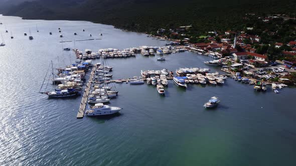 Aerial View on the Pier with Moored Yachts and Boats Located on the Shore of Little Town Demre